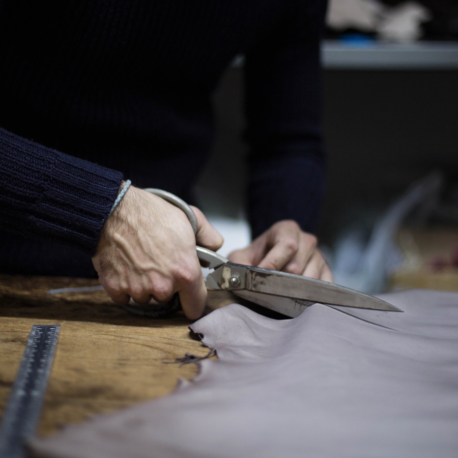 The leather for each pair of gloves is cut by hand. Photo by Stephane Buttice.