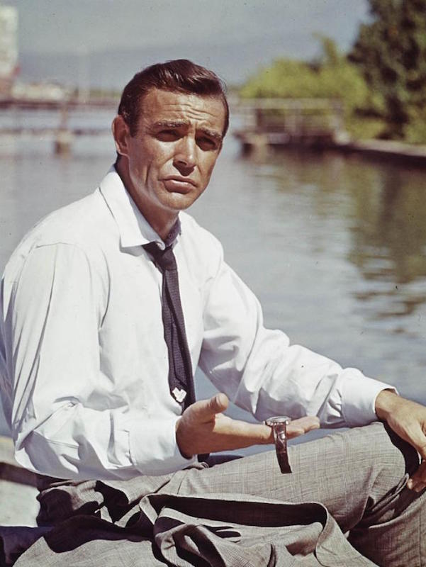 Connery holds out the Submariner with Radium dial on a two-peice leather strap, worn in Dr. No.