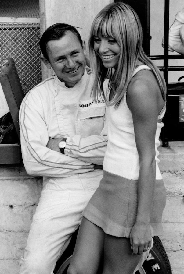 McLaren lounges with an admirer before the 1967 Italian Grand Prix.