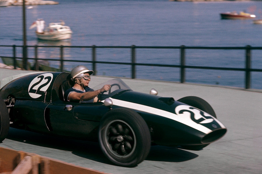 Speeding through Monaco in the Grand Prix of May 1959 in a short sleeve T-shirt, bare hands and an open face helmet. (Photograph by Bernard Cahier).