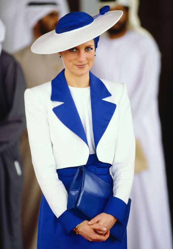 Diana wears a royal blue and ivory ensemble, with a silk turban and Philip Somerville hat in Dubai, 1989.