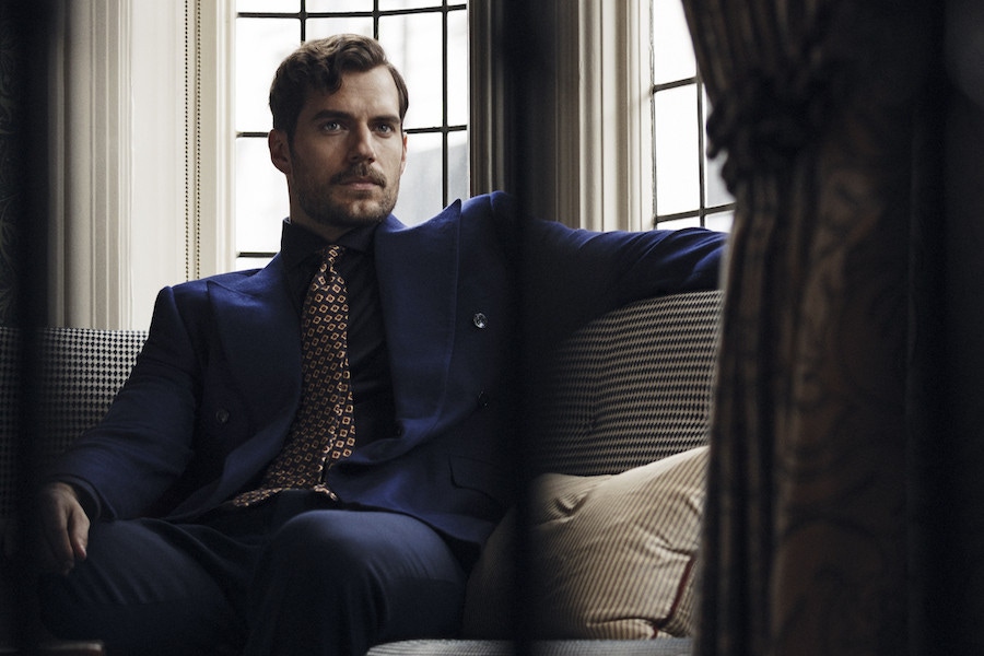 Navy cotton jersey shirt, Pal Zileri at Harvey Nichols; navy cotton drill trousers New & Lingwood. Navy and gold silk printed tie, property of The Rake. Bespoke navy double-breasted wool blazer, Cifonelli, property of Henry Cavill.