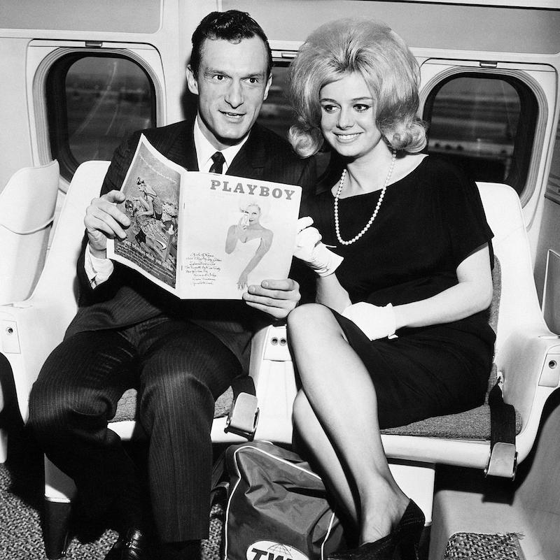 The Editor and Publisher of Playboy with Cynthia Maddox, the cover girl on the February issue of his magazine in 1962, arriving by TWA superjet from Chicago. They are to attend a party given by Ella Fitzgerald at the Basin Street East in honour of winners of the Playboys jazz poll.