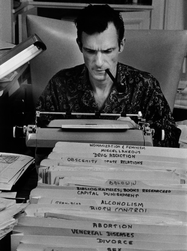 Hugh Hefner, Playboy founder, typing at his desk in his mansion in Las Vegas, 1966.