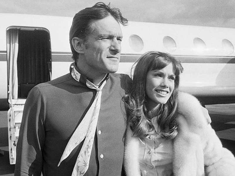 Hefner with one of his many girlfriends Barbi Benton at Paris airport, 1969.