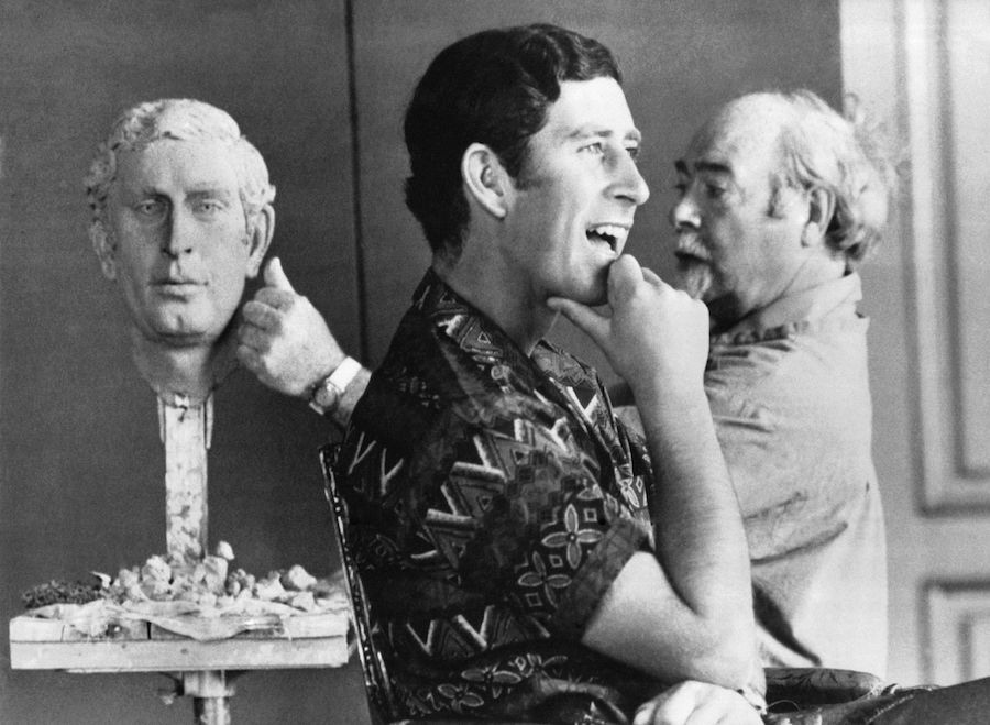 The Prince of Wales poses for sculptor David McFall at the Buckingham Palace. He looks relaxed off duty, in an abstract print shirt. Photo by Keystone-FranceGamma-Rapho via Getty Images.