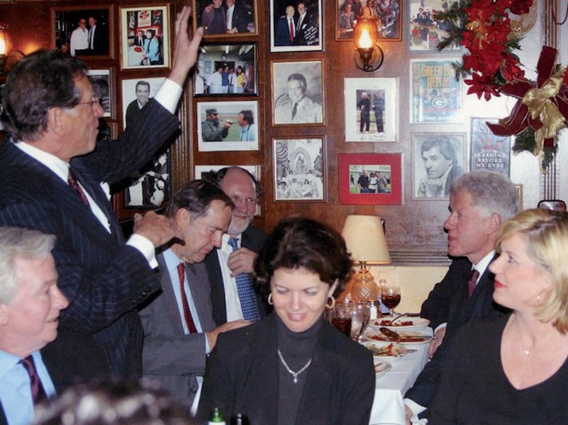 President Bill Clinton breaks bread with Thomas Kean and Jon Corzine as Frank Pellegrino Sr. (standing) regales them, 2003. By Nancy Ellison/Polaris Images.