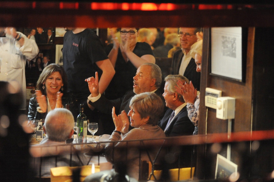 Bo Dietl (seated, center) holds court this week at his table at Rao's, which he's had every Thursday since 1977. Photo by Christopher Sadowski.