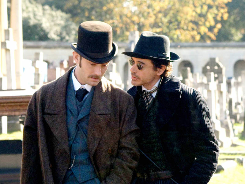 Jude Law and Robert Downey Jr wear heavy overcoats, three-piece suits and hats in the mystery period action film Sherlock Holmes, 2009.