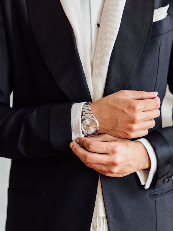 Jonathan Alexander Edwards wears a black three-piece dinner suit by Neapolitan tailors Solito complete with turn-back cuffs, a double cuff dress shirt and an Omega Seamaster wristwatch. He displays here the correct amount of shirt to show for formal dress. Photograph by Jamie Ferguson.