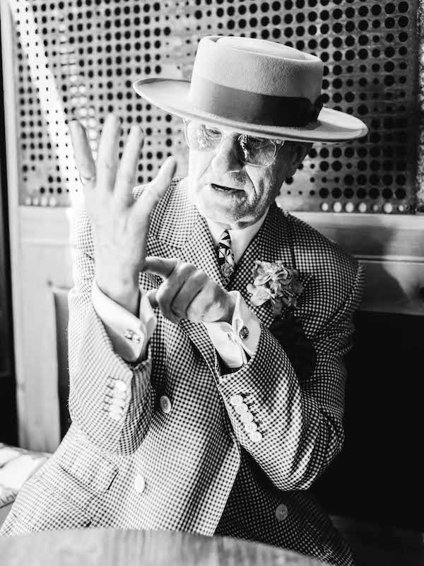 George Skeggs wear a check dress coat with a five-button cuff paired with a double cuff shirt, both by Soho tailor Mark Powell, alongside gold plated double-sided cufflinks from the British History Museum. Photograph by Jamie Ferguson.