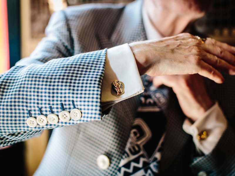 Artist George Skeggs wear a check dress coat with a five-button cuff by Soho tailor Mark Powell paired with a double cuff shirt also by Mark Powell, alongside gold plated double-sided cufflinks from the British Museum. Photograph by Jamie Ferguson.