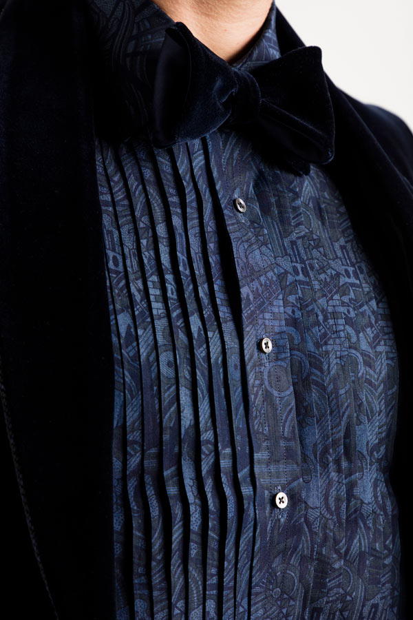 The dinner shirt features pleats at the front.