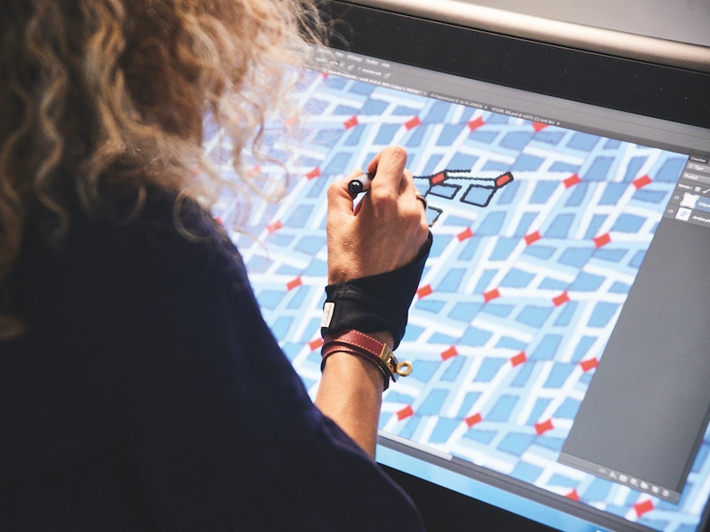 An engraver carefully tracing a tie design. Photograph by Kim Lang.