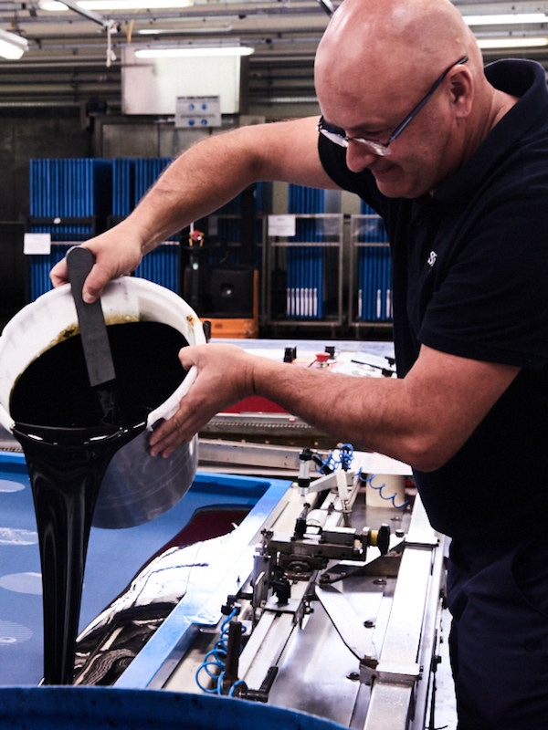 A workman preparing the printing stage. Photograph by Kim Lang.