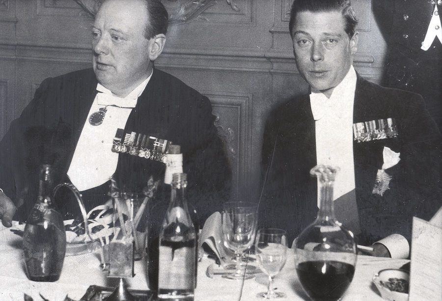 Surrounded by carafes of wine, Churchill dines with Edward VIII at the Savoy in 1930.