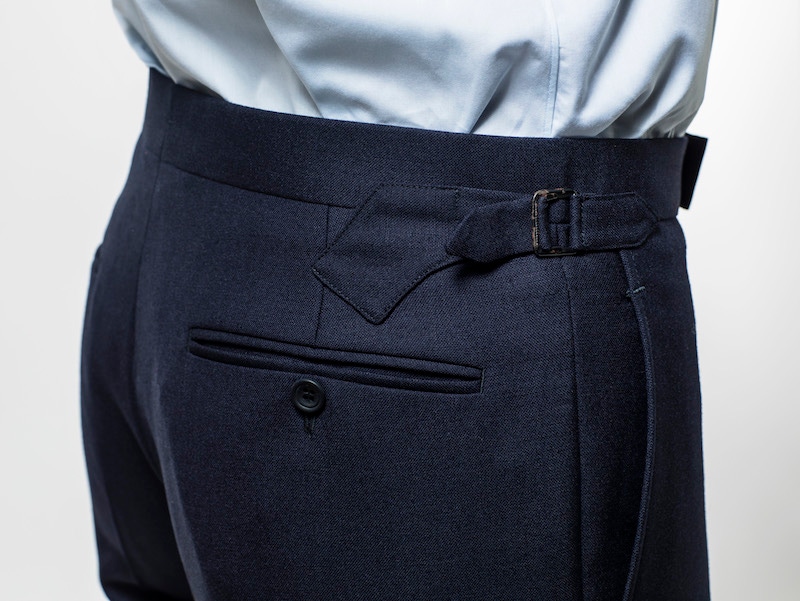 Chester Barrie’s trousers feature twin ‘pistol’ side adjusters and a clean waistband.