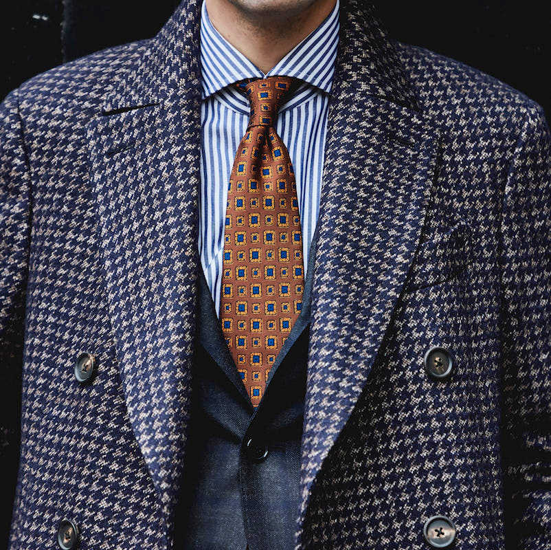 Lardini's double-breasted houndstooth overcoat worn with a 100Hands striped shirt, both of which will be at the pop-up.