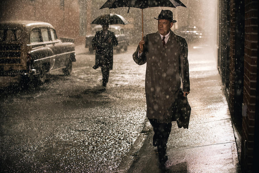 Tom Hanks wearing a mackintosh-style raincoat in Bridge of Spies, 2015.