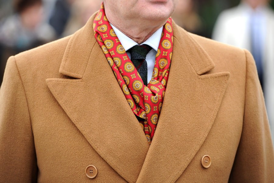 A camel overcoat is paired with a complementary patterned silk scarf for more formal occasions. Photograph by Gentleman's Gazette.