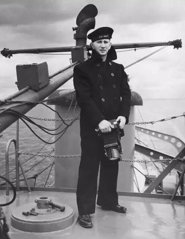 American Naval photographer Morris Engel wears a traditional double-breasted reefer jacket on the deck of a ship, circa 1945.