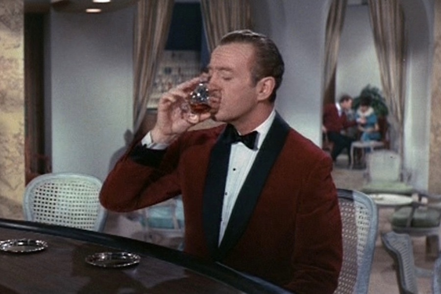 David Niven dons a red velvet dinner jacket with bow tie and white dress shirt as Sir Charles Lytton in The Pink Panther, 1963.