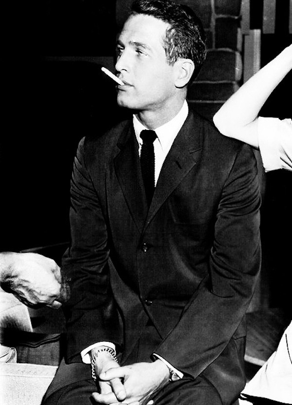 Paul Newman wears a single-breasted suit paired with a white shirt and solid coloured tie on the set of Rally Round The Flag, Boys!, 1958.