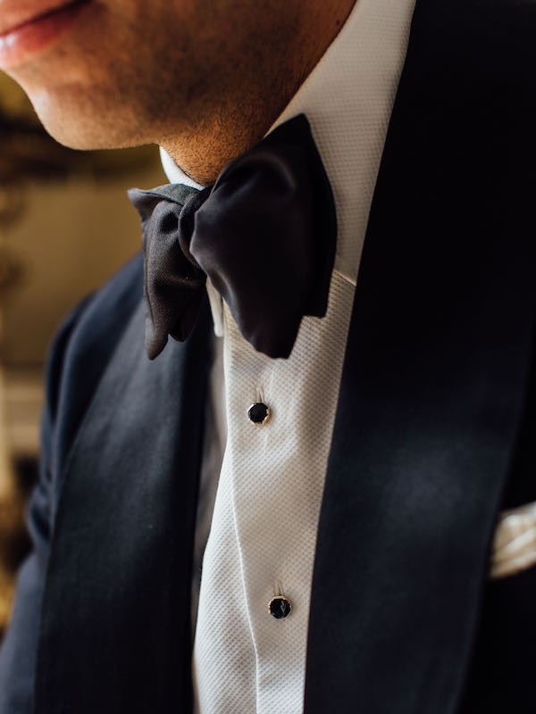 An ivory spun silk scarf, silver and onyx dress studs and links, and a moiré bow tie are all from Budd Shirtmakers and demonstrate the correct way to wear black tie. Photograph by Jamie Ferguson.