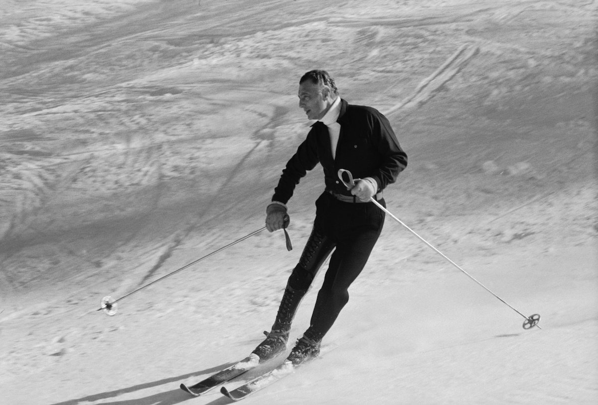 Gianni Agnelli looks sleek and sophisticated in an all-in-one dark ensemble with a belted waist paired with a white turtle neck while skiing near the Sestriere ski resort in Italy, 1967.