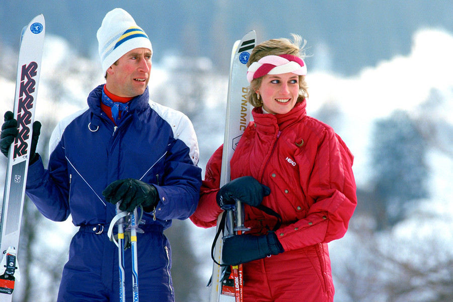 Prince Charles and Princess Diana are testament to the fact that colour can work on the slopes. Here they both don bright jumpsuits with equally bright roll necks while enjoying a holiday in Klosters, Switzerland, 1989.