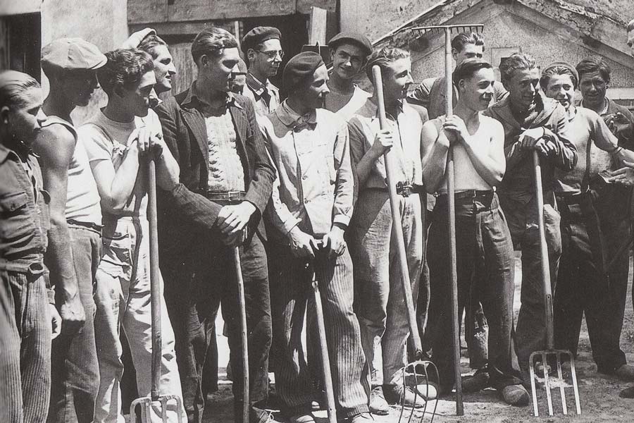 A group of young men wearing traditional workwear.