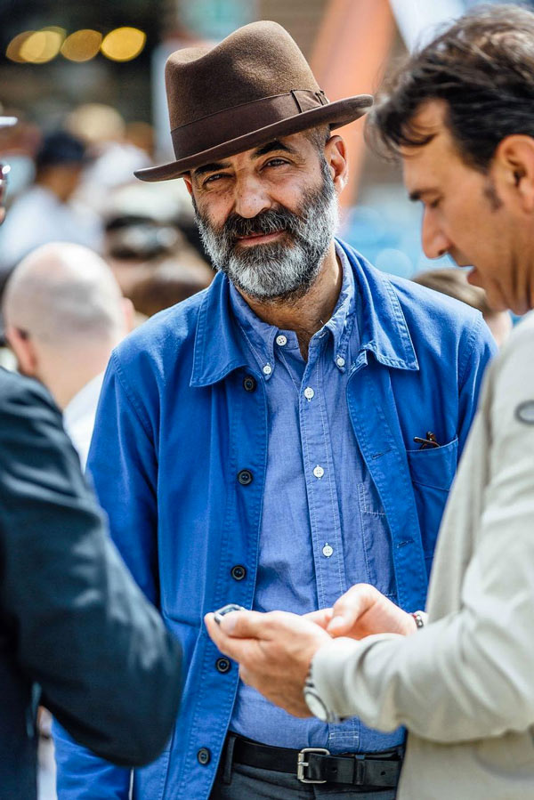 In Florence, a man wears a blue chore coat with a chambray Oxford shirt. Photograph by Jamie Ferguson.