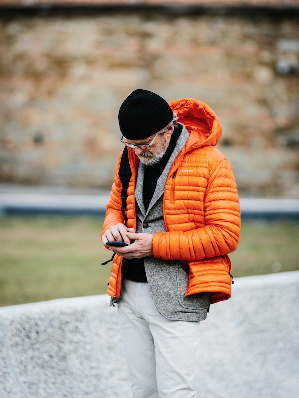 Layered over tailoring in a bold colour such as crimson or orange warms up an otherwise monochrome outfit. Photo by Jamie Ferguson.