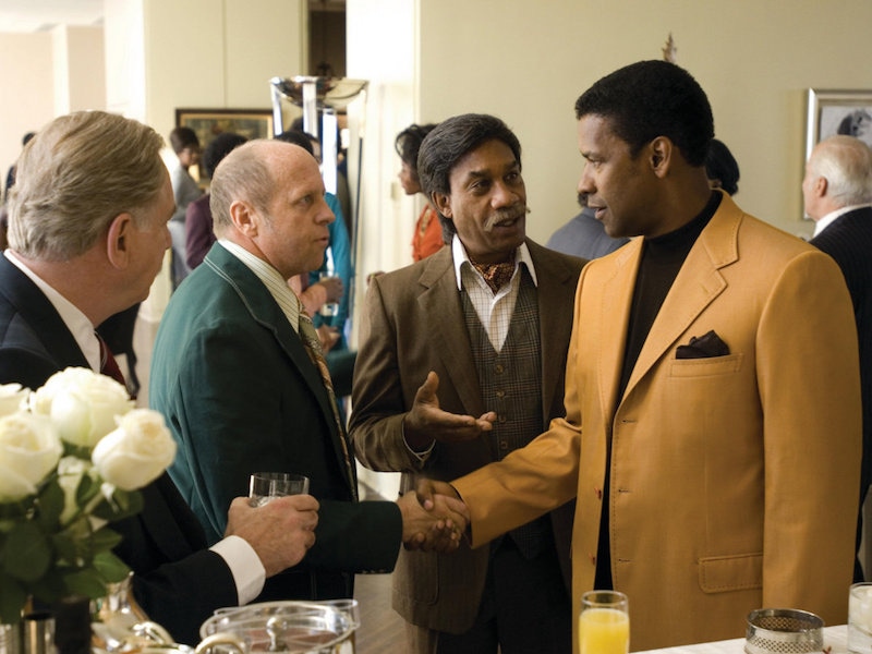 A signature Frank Lucas touch of matching two items when wearing tailoring; here, it's his pocket square in chocolate brown silk and his cashmere mockneck.