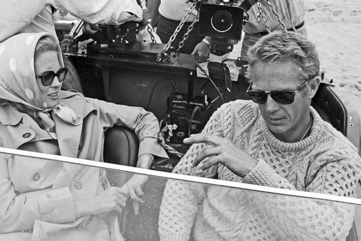 McQueen pictured with Faye Dunawa wearing a vintage cable knit sweater paired with his signature Persol frames in The Thomas Crown Affair. 1968.