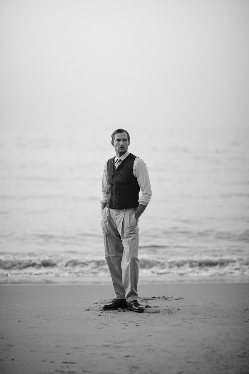 Sometimes a waistcoat, shirt and tie will be more than adequate, as the coat sits just above the start line of the pleats. The model wears charcoal grey double-breasted cotton-jersey waistcoat, Brunello Cucinelli; grey and blue floral silk printed tie, Rubinacci for The Rake; cream cotton checked shirt, Gieves & Hawkes; pistachio green cotton balloon trousers, Caruso; chocolate brown kudu leather boots, Trickers. Styled by Jo Grzeszczuk, shot by Kalle Gustafsson.