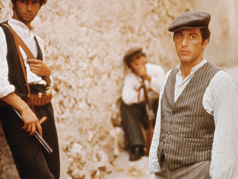 Michael Corleone's waistcoat and trousers are cut in slightly different striped cloths, but complement each other in tonal greys. The waistcoat features jetted ticket pockets and is worn over a collarless shirt in The Godfather, set in 1945.