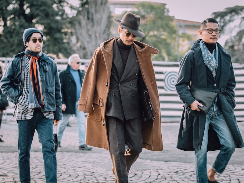 BEAMS Fashion Director Shuhei Nishiguchi showcasing how brown tonal tailoring is done with a duffle coat hanging across his shoulders.