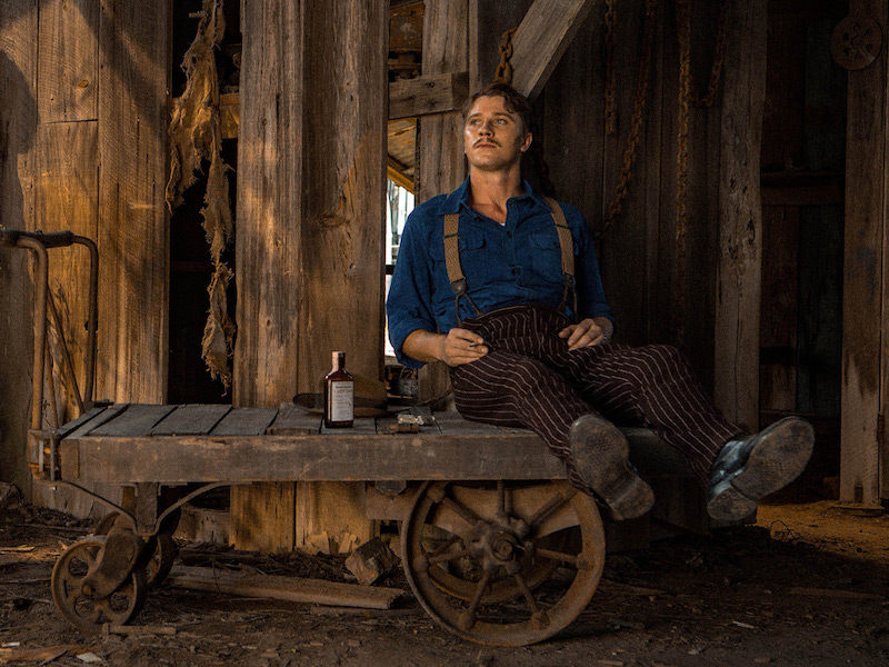 Set in the 1940s, Mudbound's Jamie McAllan returns from war to work on his brother's farm. Even so, he wears pinstriped tailored trousers and braces over a heavy cotton blue shirt.