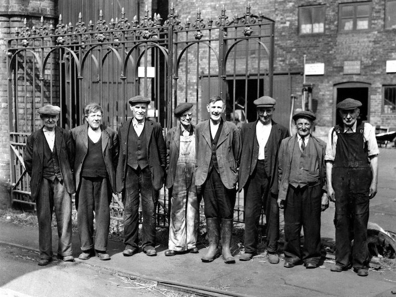 Loose-fitting overalls and generously cut tailoring allow for movement and flexibility for factory workers at Ironbridge, England circa 1940s.