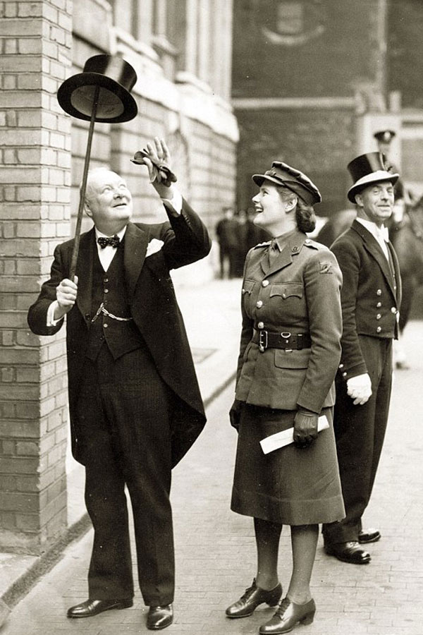 Churchill in tails, sporting his signature spotted bow tie, a silk top hat and cane with his daughter Mary, 1943.