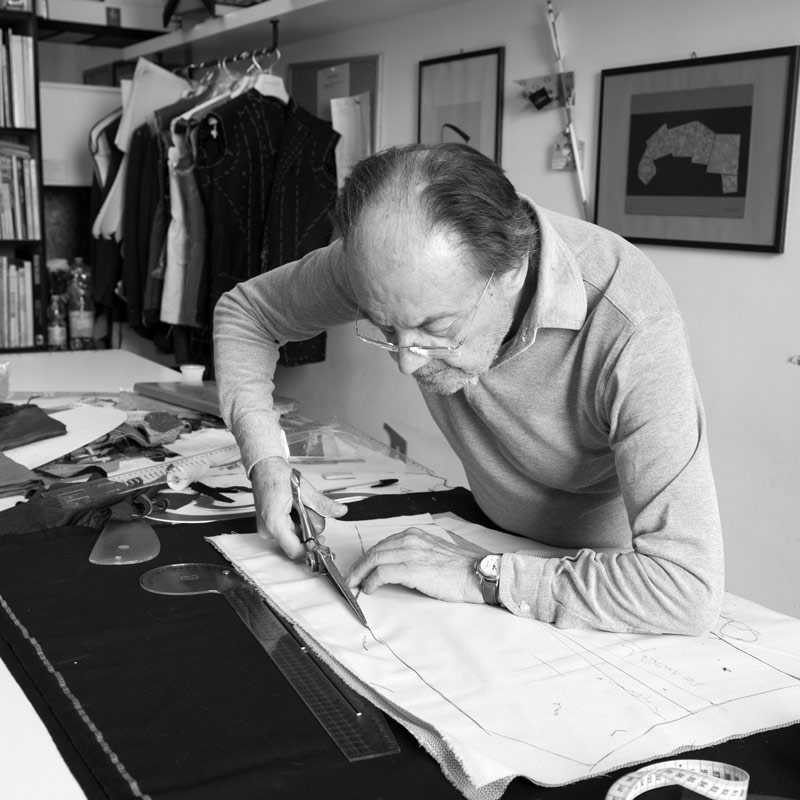 Luigi Dalcuore cutting a jacket pattern.