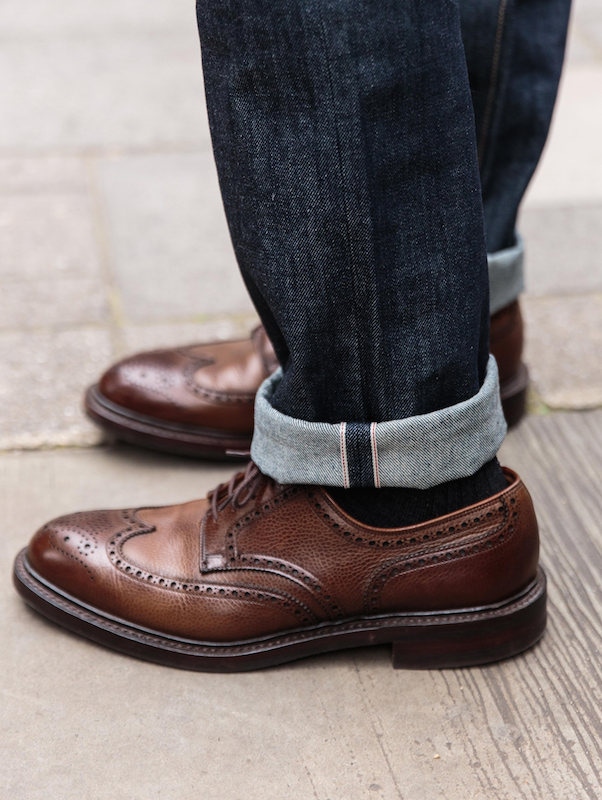 A pair of jeans can be dressed up easily by a sharp pair of brogues. Here, Blackhorse Lane’s E5 jeans are worn with a pair of Crockett & Jones shoes.