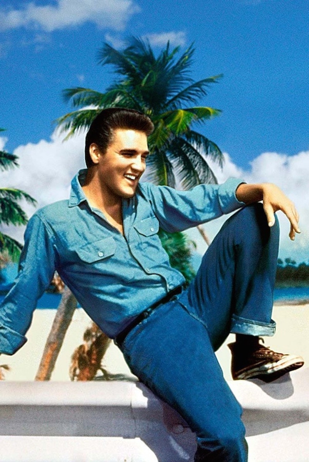 Elvis Presley wearing double denim with high-top canvas sneakers, circa 1950s.