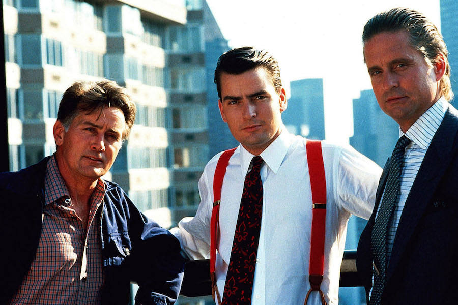 One of the most memorable garments was Gekko's incredibly bold horizontally-striped shirt. Here he is pictured on set with Michael and Charlie Sheen, 1987. Photograph by AF archive/Alamy.