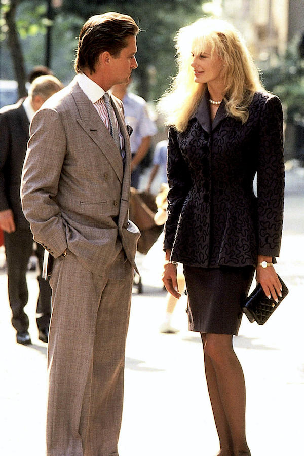 Gekko's grey double-breasted suit is noticeably padded in the shoulders to form a masculine silhouette. His jacket is nonchalantly only buttoned on one row, and his wide-legged trousers illustrate generous drape on his slim figure. Photograph by 20th Century Fox Film Corp./courtesy Everett Collection/Alamy.