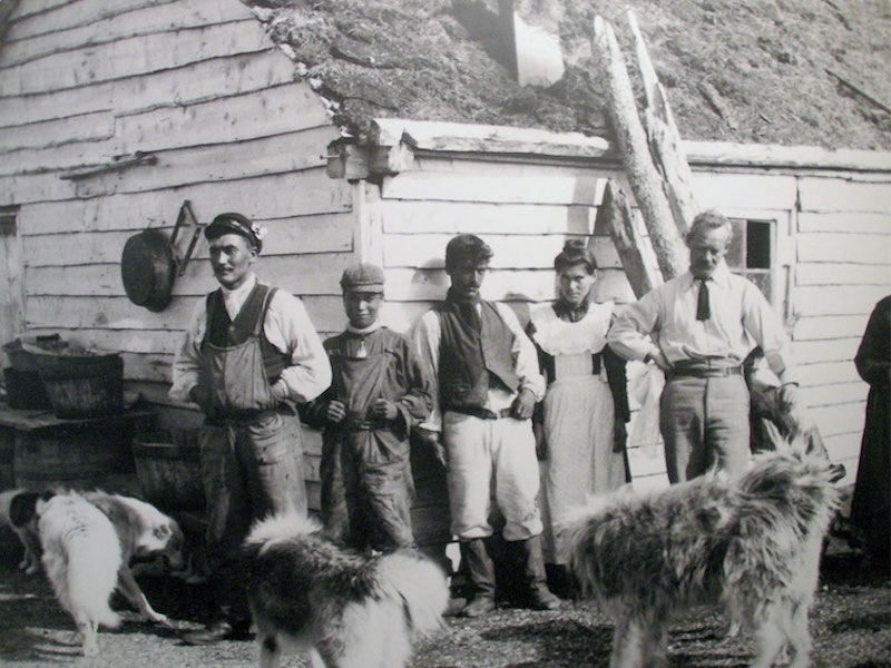 Sir Wilfred Grenfell poses with local fisherman on the Labrador coast, a few of which are wearing overalls made from Grenfell Cloth, circa 1935.