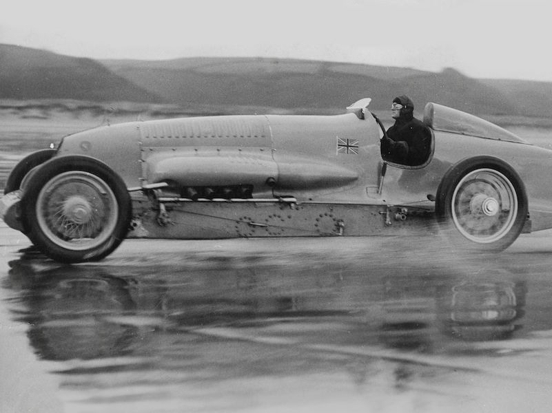 Sir Malcolm Campbell testing the 450 Hp Motor Car in one of his driving suits made from Grenfell Cloth.