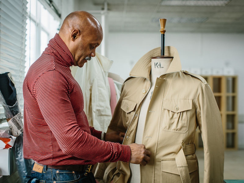 Joslyn Clarke, Creative Director at Grenfell, works on a sample belted safari jacket.  Photo by Jamie Ferguson.