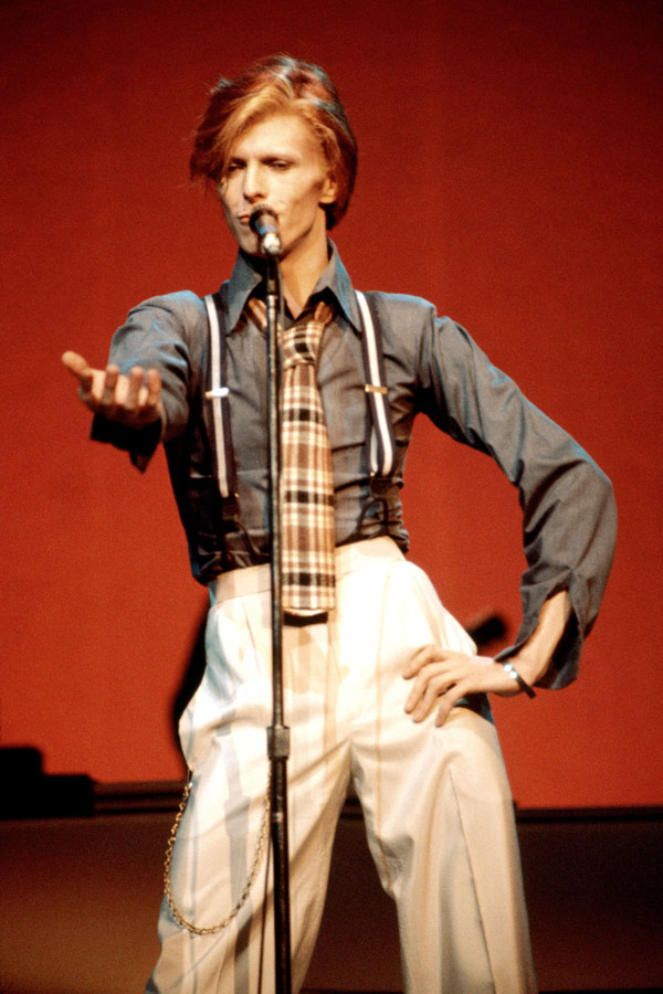 David Bowie wears braces on stage, circa 1974.